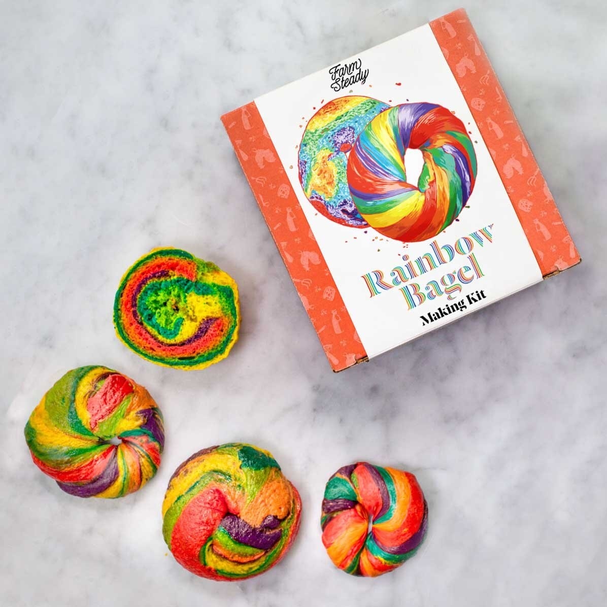 a bunch of rainbow bagels next to a rainbow bagel making kit