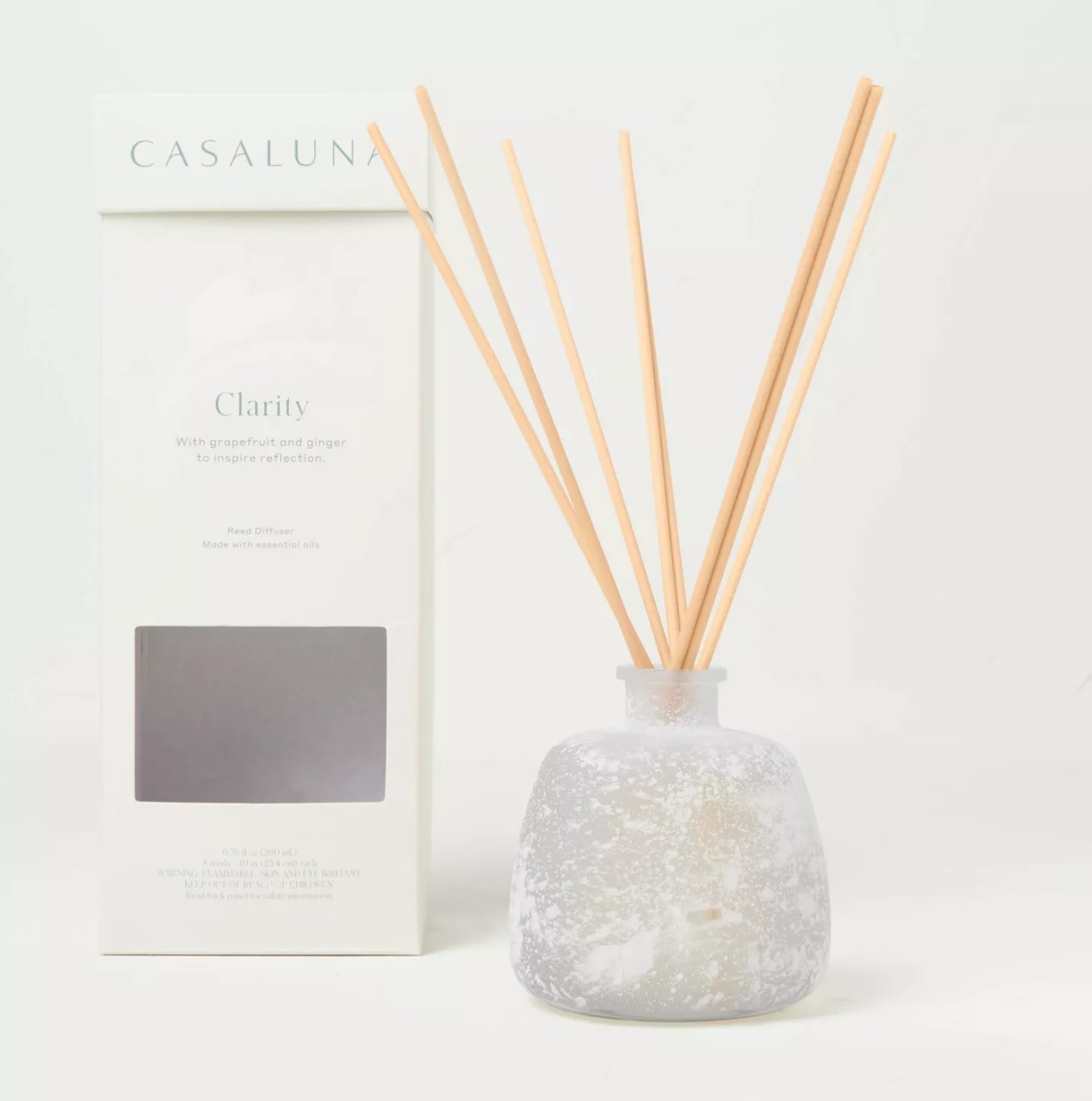 The diffuser in a speckled holder with light wood sticks