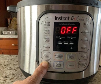 reviewer pressing the saute button on the cooker. there are also buttons for things like soup, poultry, slow cook, rice, yogurt, and porridge