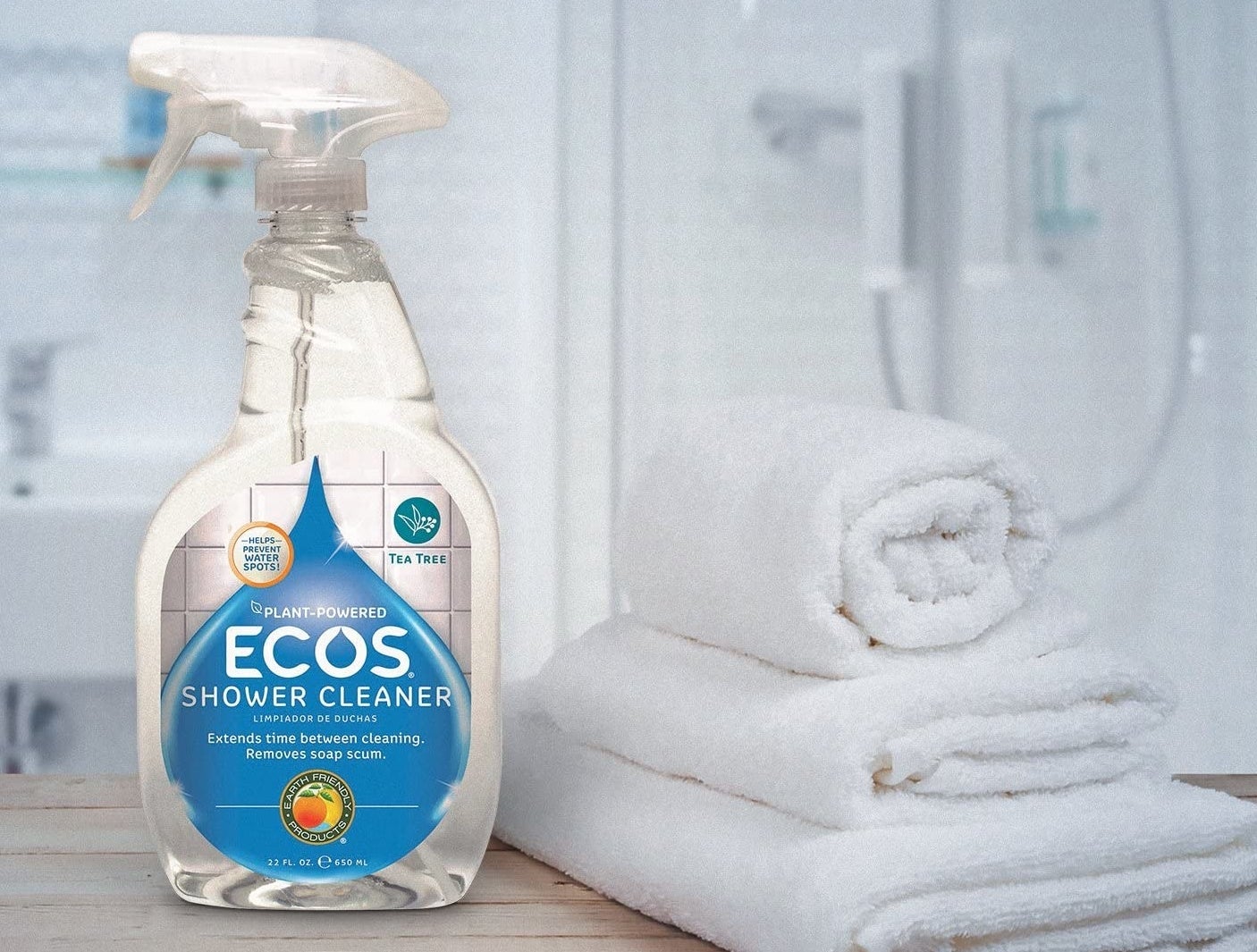 bottle of ecos shower cleaner on bathroom counter next to towels