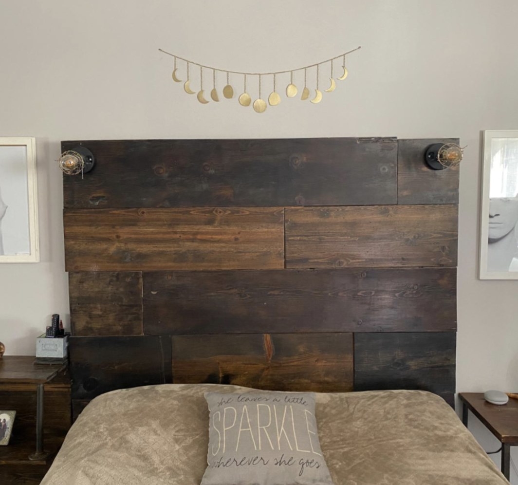 A moon wall decor above a bedroom headboard