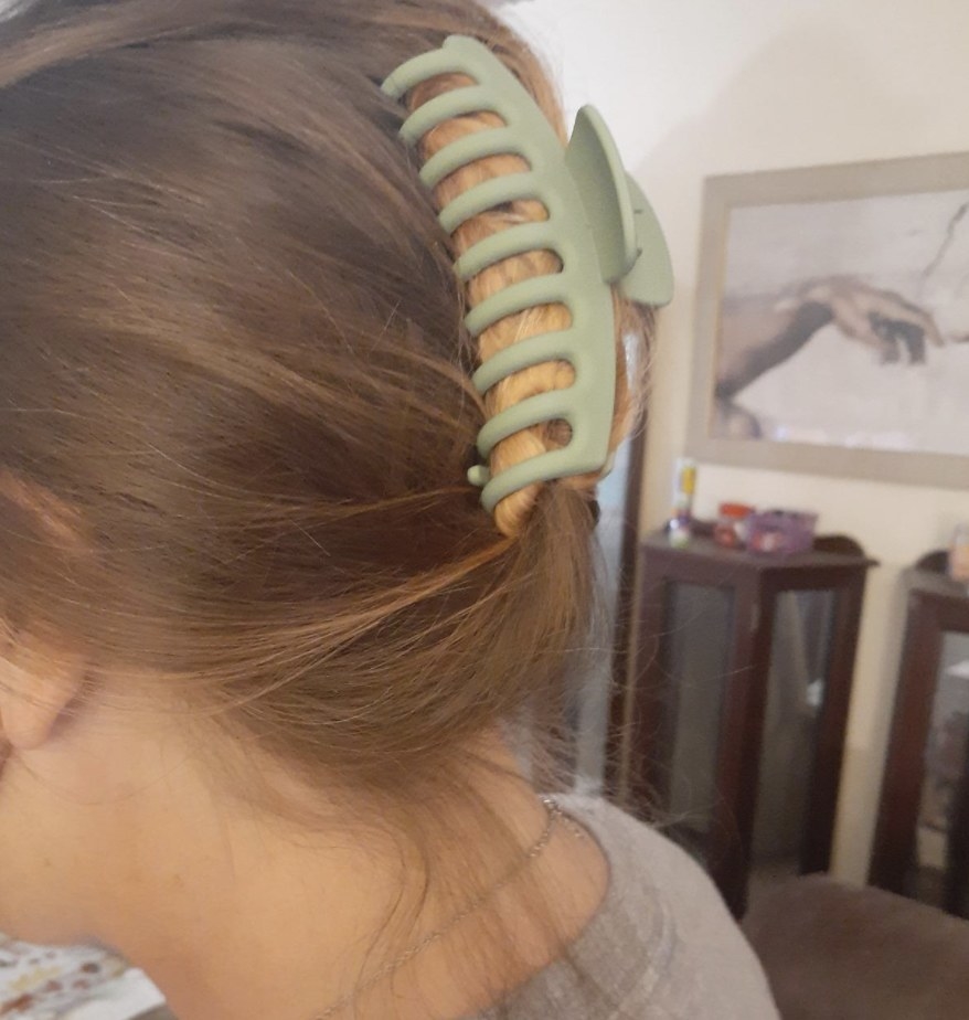 A person with a green hair clip in their hair