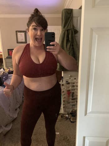 reviewer wearing the burgundy bra with with matching leggings