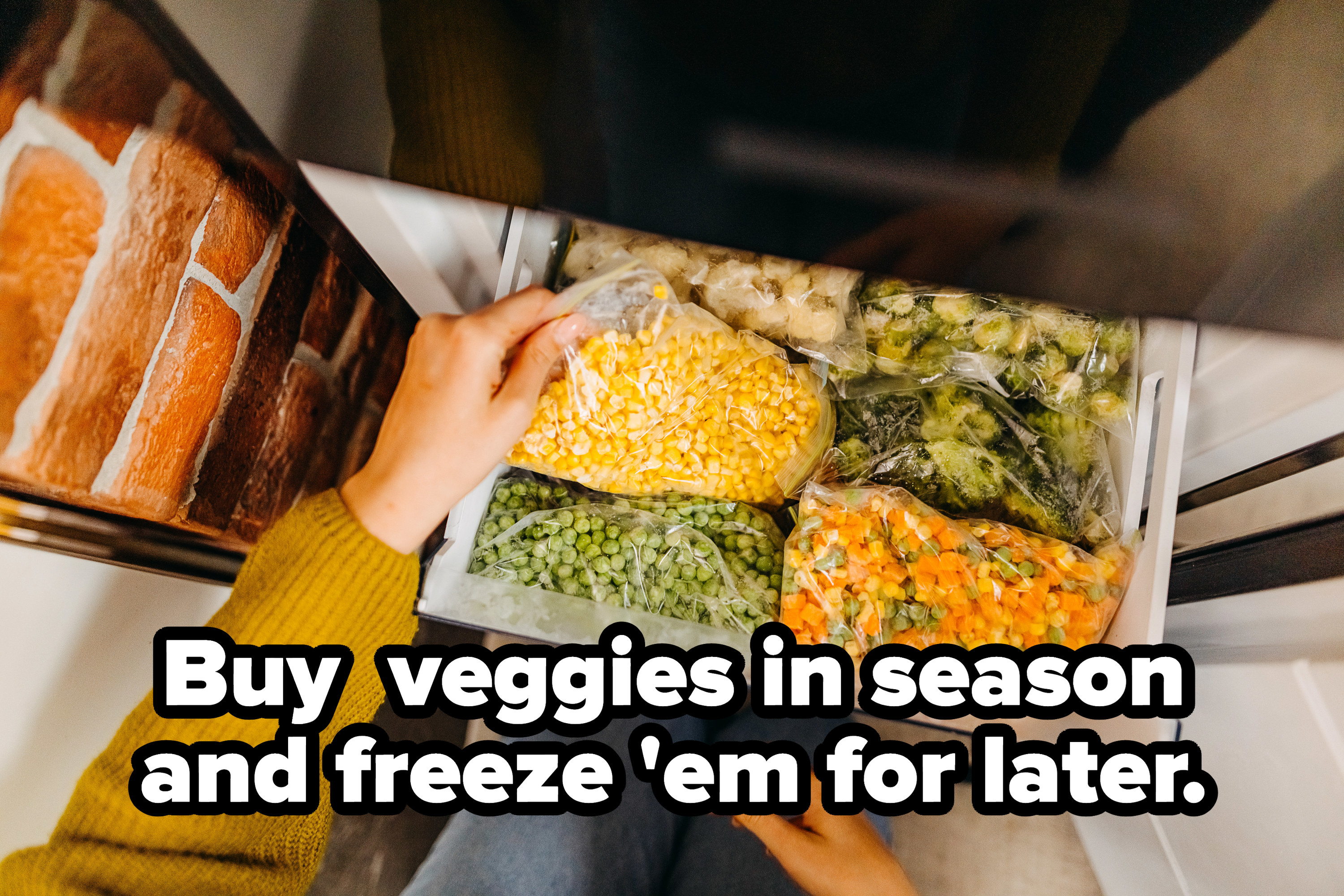 Woman putting container with frozen mixed vegetables in the refrigerator