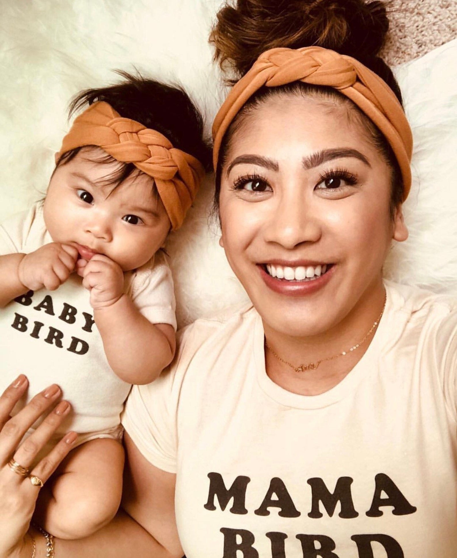 a baby and a mom in matching knotted camel brown headbands