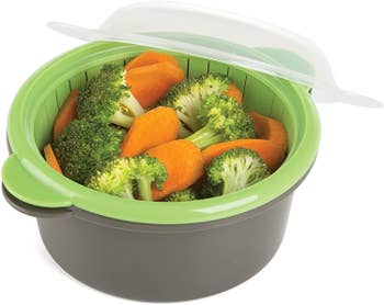 the green and gray steamer filled with carrots and broccoli
