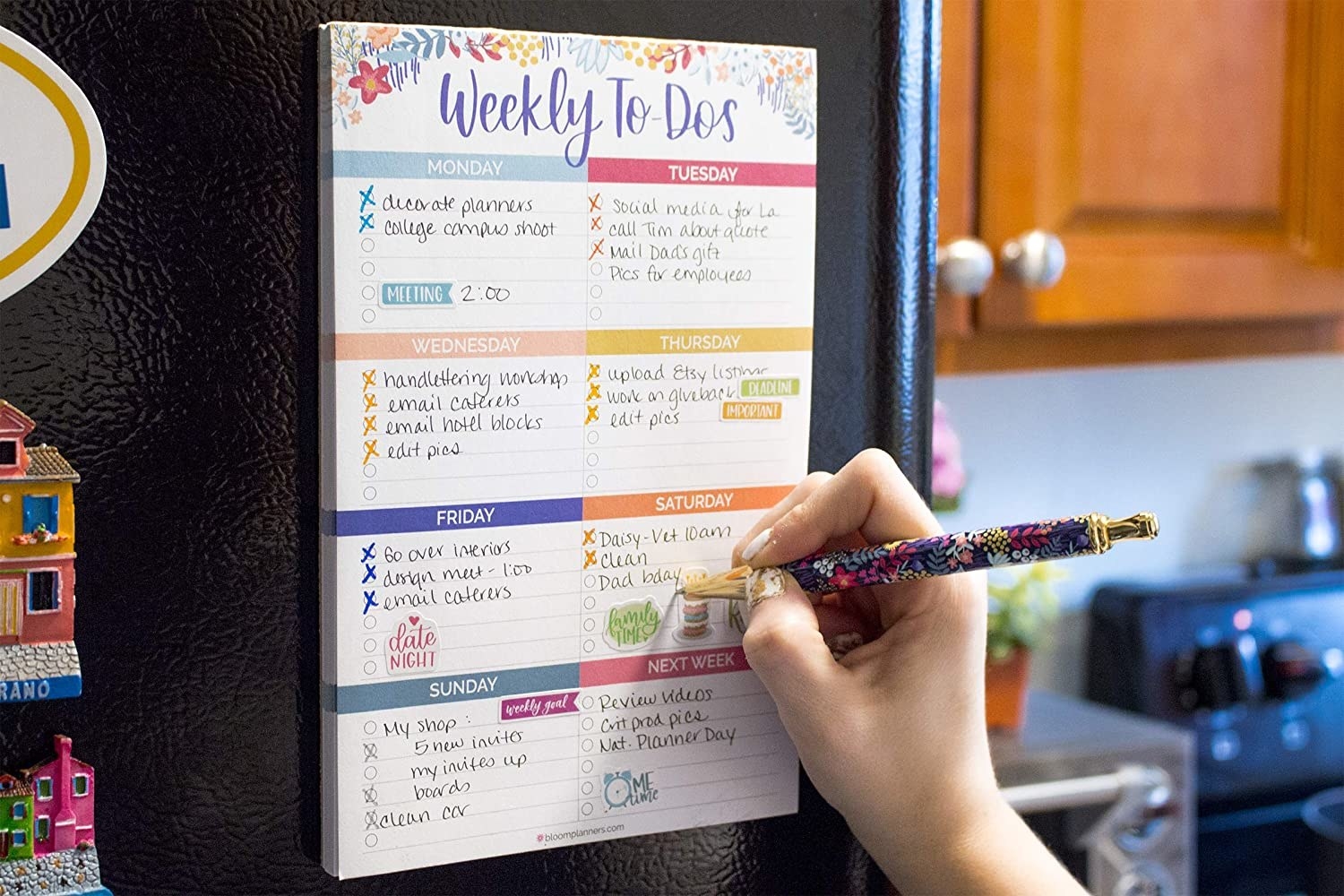 Model writing on weekly to do bad hanging on refrigerator 