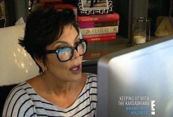 Meme of Kris Jenner reading something on her computer with her mouth open in awe