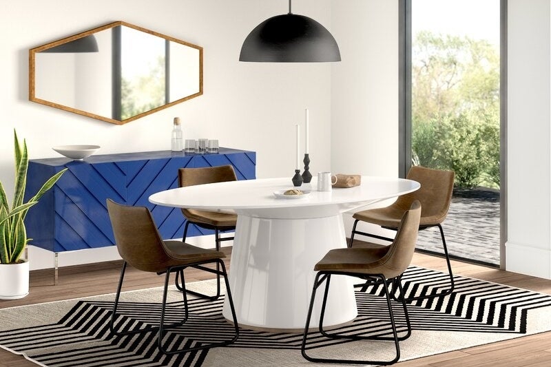 White glossy pedestal table with oval surface