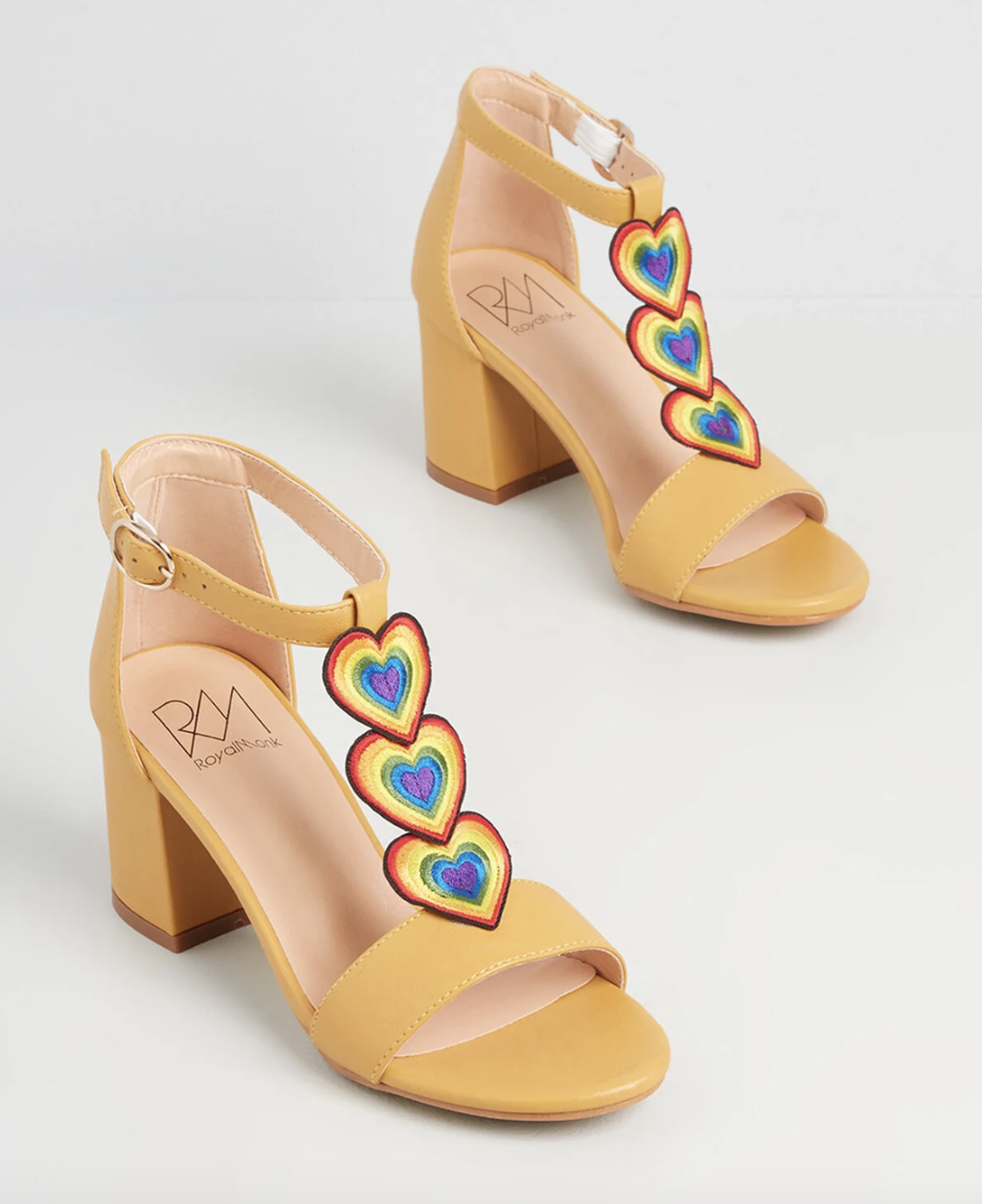 yellow heeled t-strap sandals with rainbow hearts on the straps