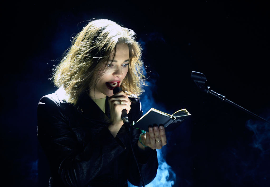 Nina Kraviz performs, reading from a small book