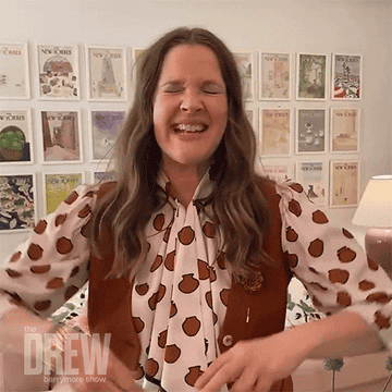 Drew Barrymore holds up two peace signs on her show