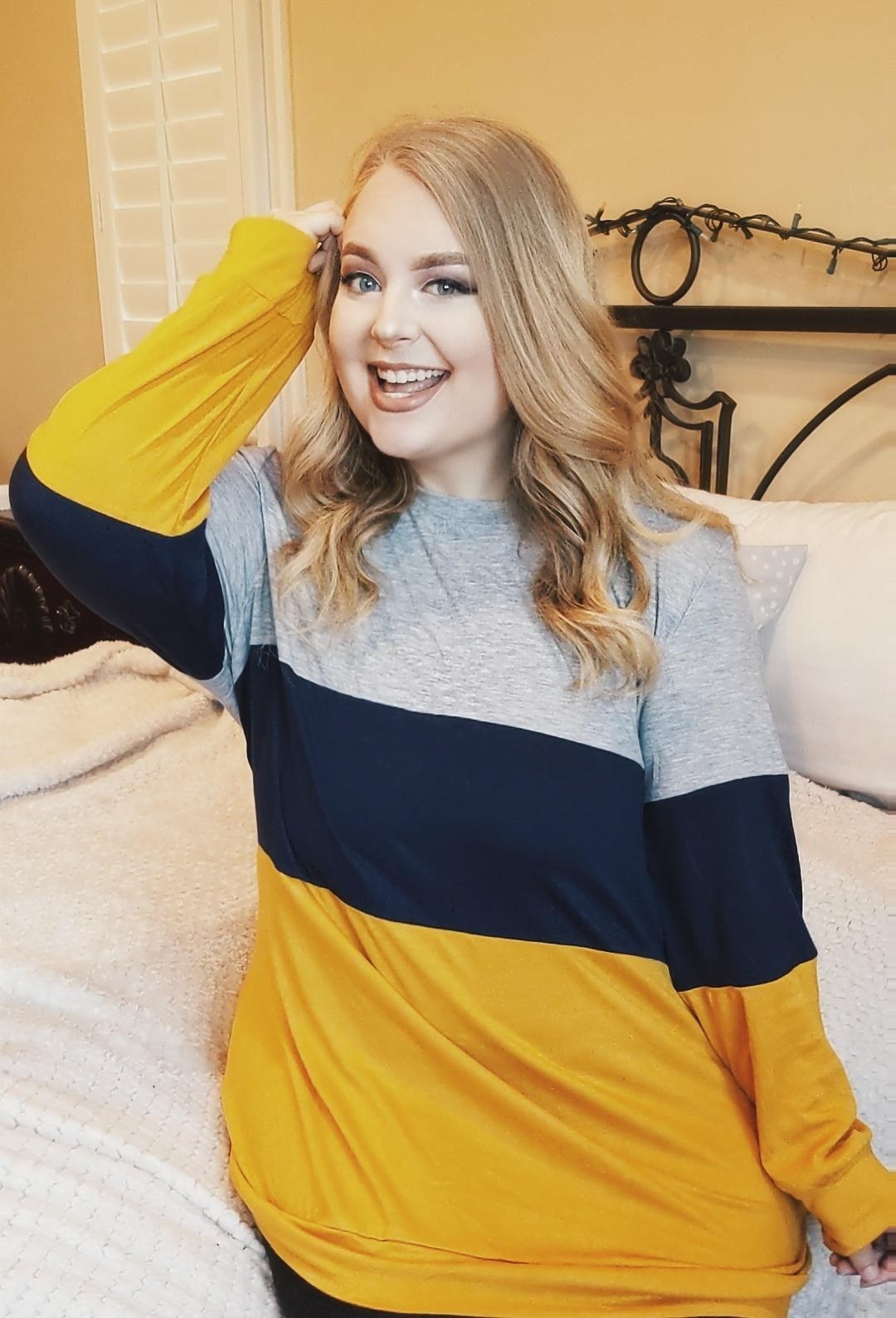 An Amazon reviewer wearing the top with blue, yellow, and gray blocks