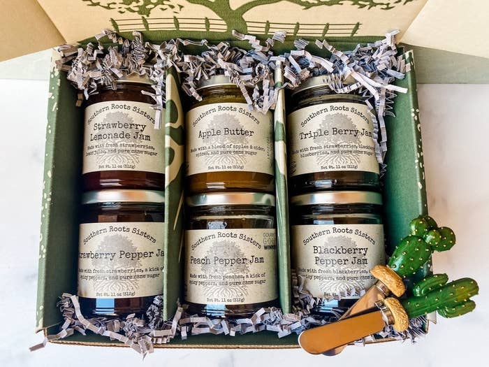 Six uniquely flavored jams inside glass jars and decorative packaging.