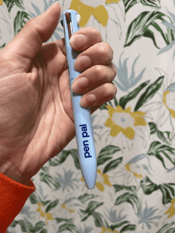 GIF of BuzzFeed writer pushing down the lip liner function of the  pen