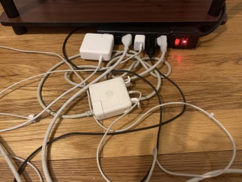 Tangled cords plugged into power strip