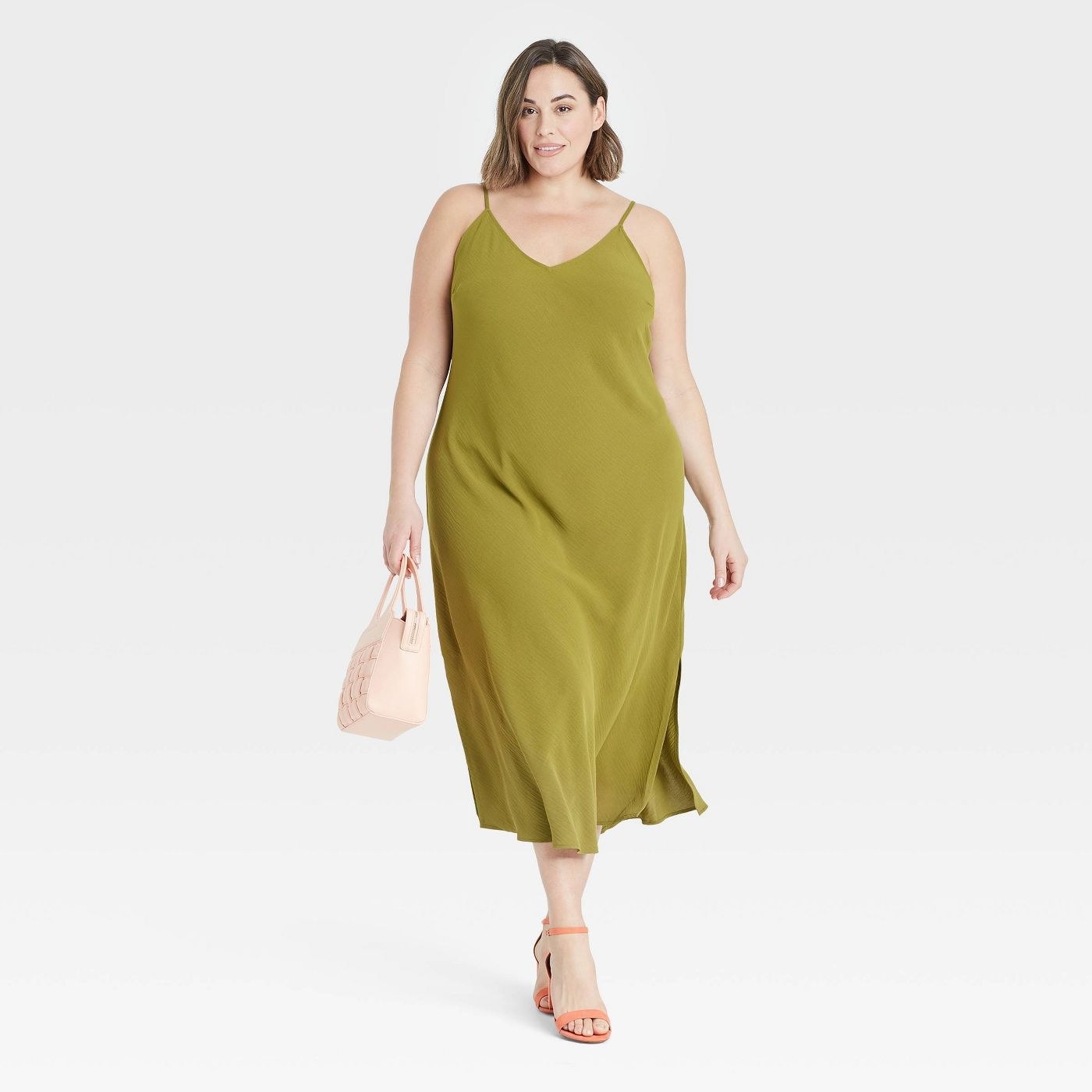 Model in green slip dress
