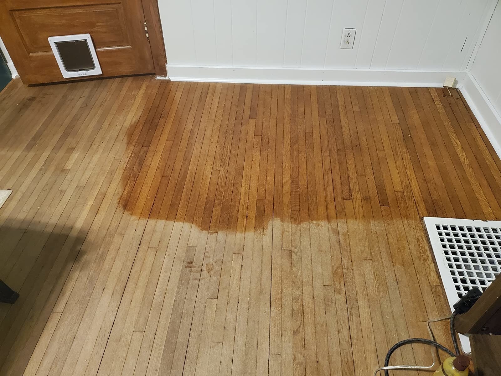 reviewer photo showing half of their floor looking completely new after applying the Feed-N-Wax to it 