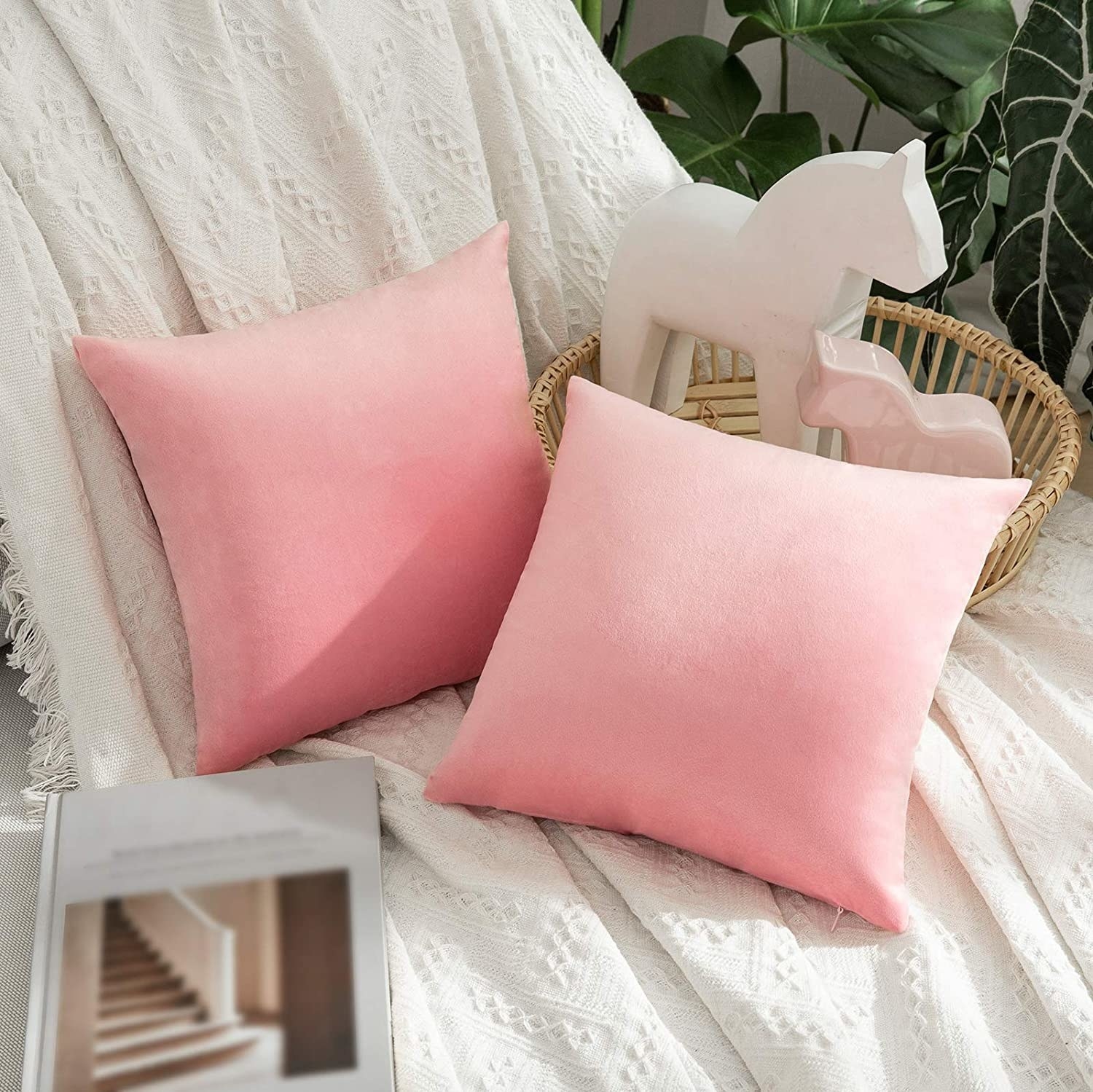 A pair of pink cushions on a white surface 