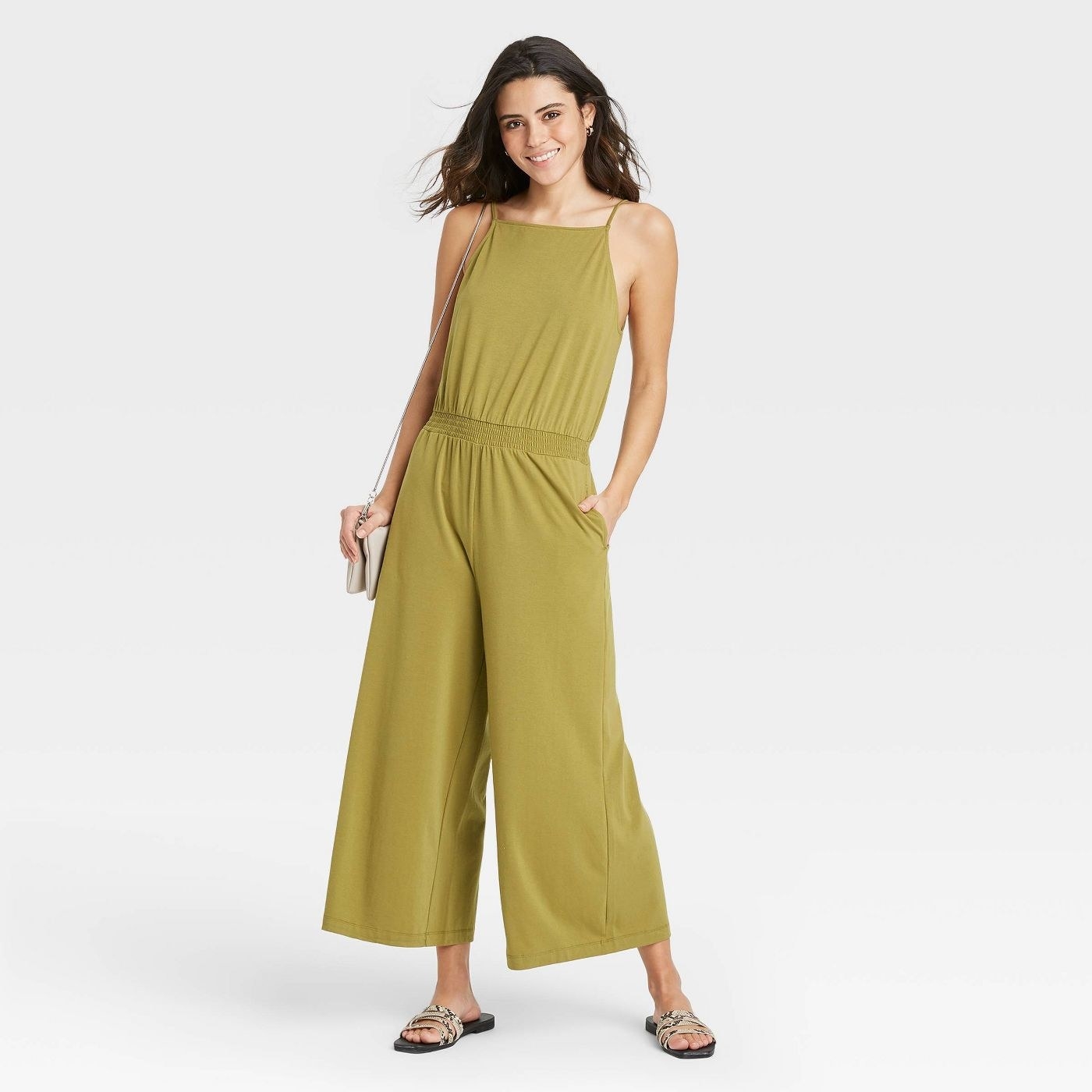Model in sleeveless smocked jumpsuit
