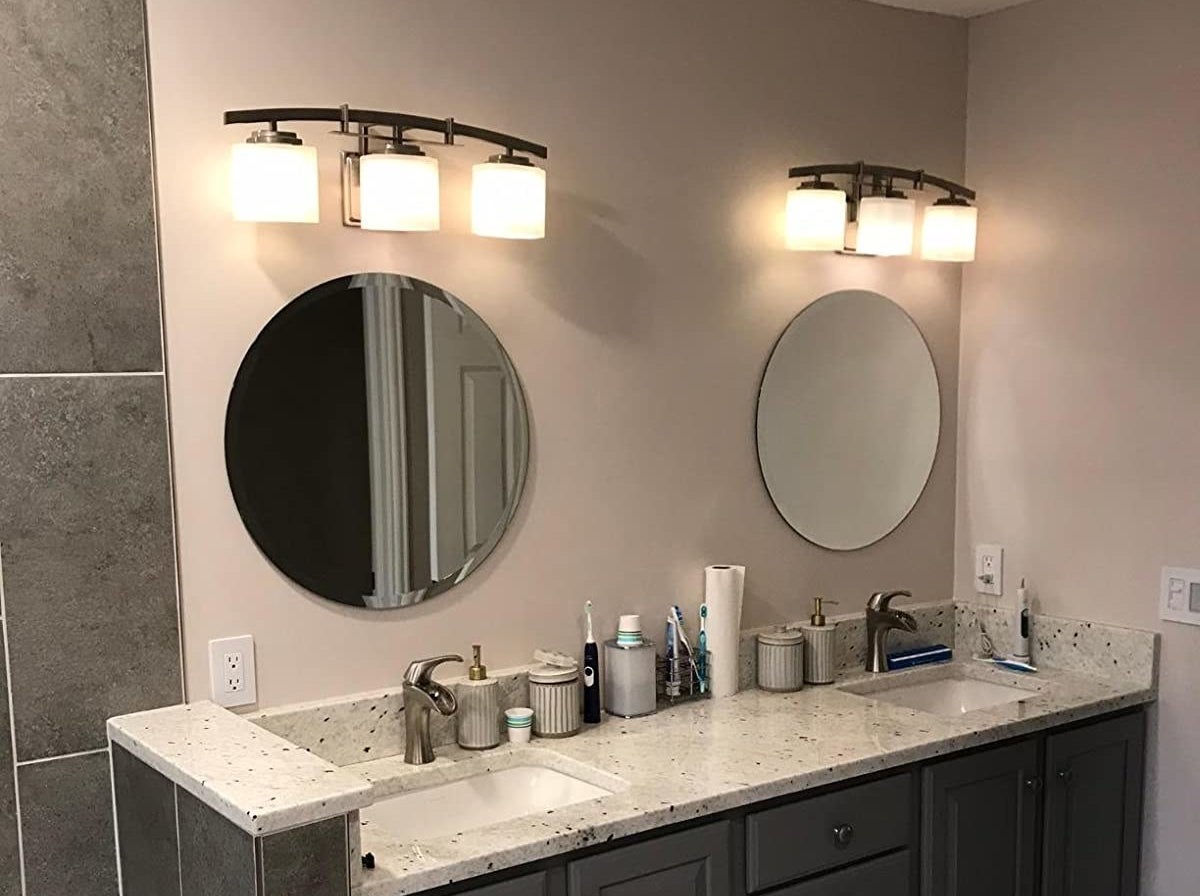 reviewer photo showing the round mirrors above the sinks in their bathroom 