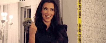 GIF of Kim fanning herself with money