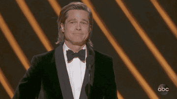 A gif of Brad Pitt at the Oscars blowing a kiss to the audience