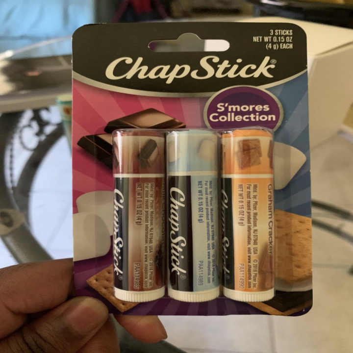 A customer review photo of them holding the ChapStick S'mores Collection