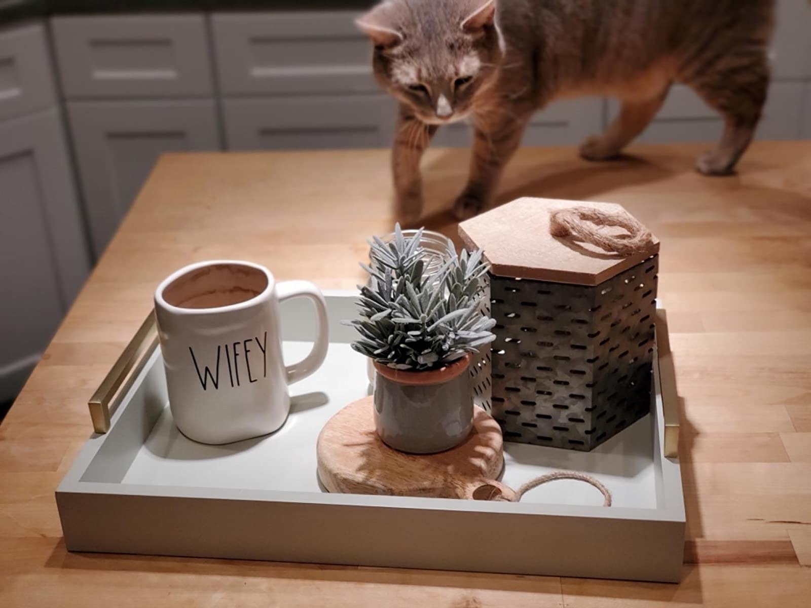 reviewer photo showing the tray on coffee table styled with coffee cup and candle