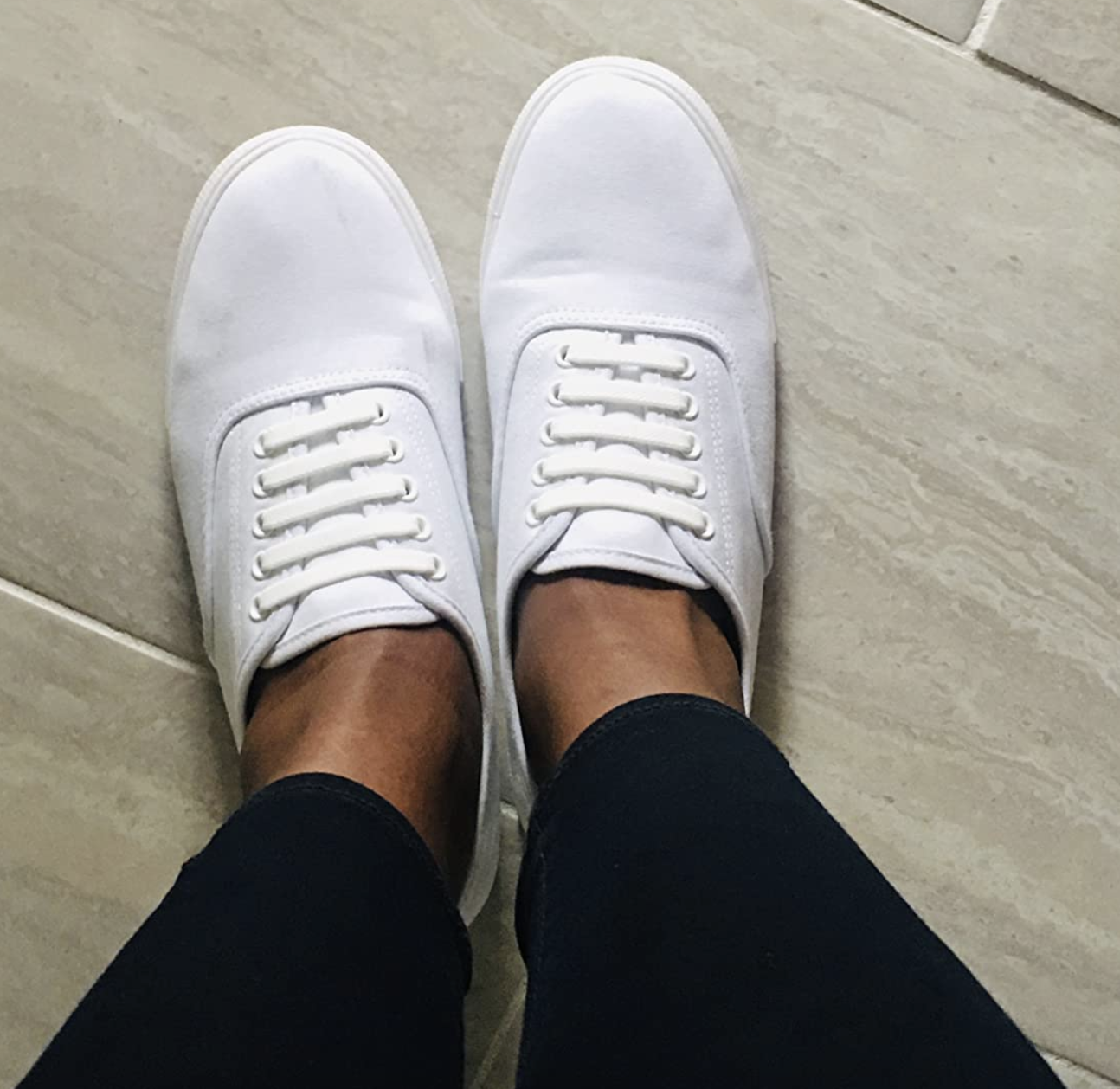 reviewer wearing white lace-up sneakers
