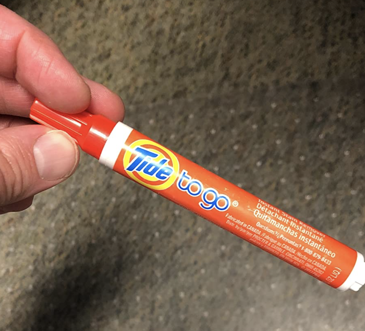 A customer review picture of them holding a Tide Pen