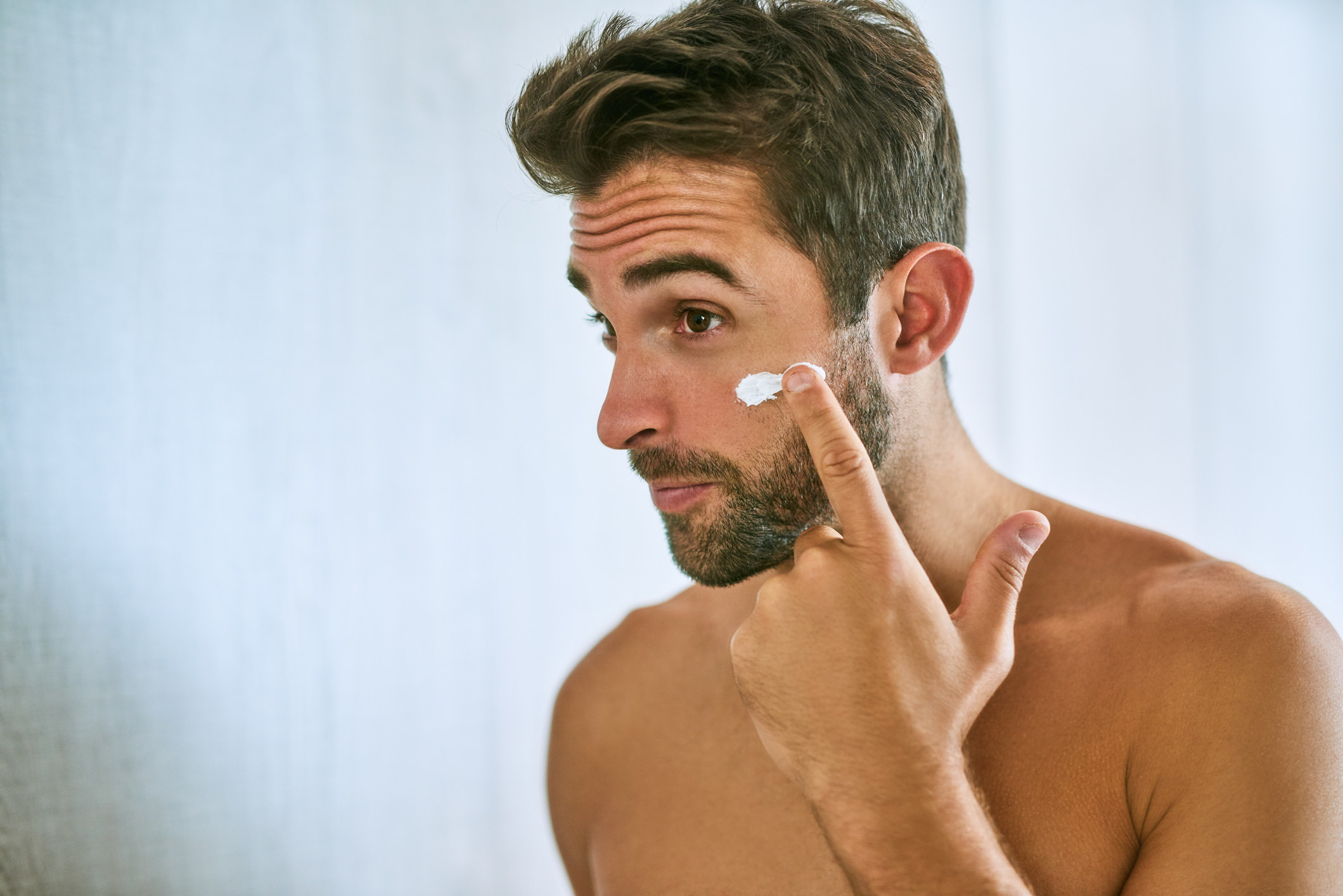 A guy moisturizing