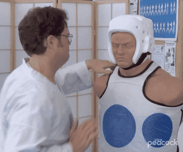 a gif of Dwight Schrute punching a karate mannequin
