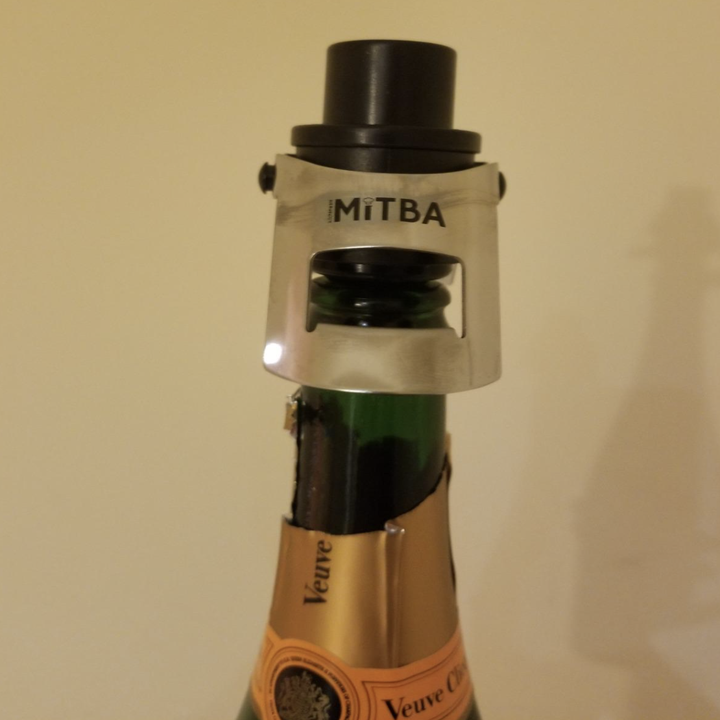A customer review photo of a champagne bottle being sealed with the sealer