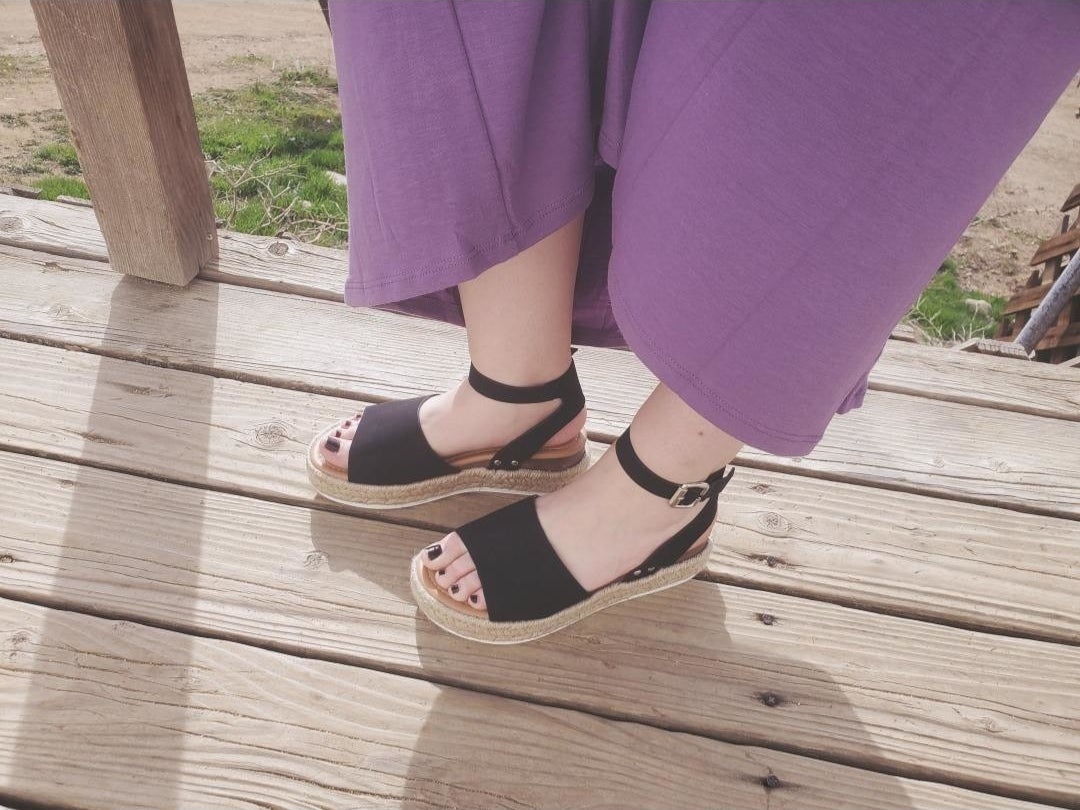 a reviewer wearing the open toe sandals in black