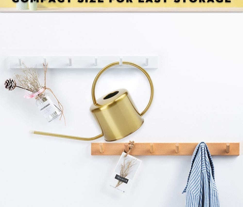 the watering can hanging on a hook