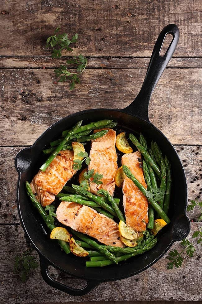 Salmon and asparagus in the skillet with our spouts and a helper handle
