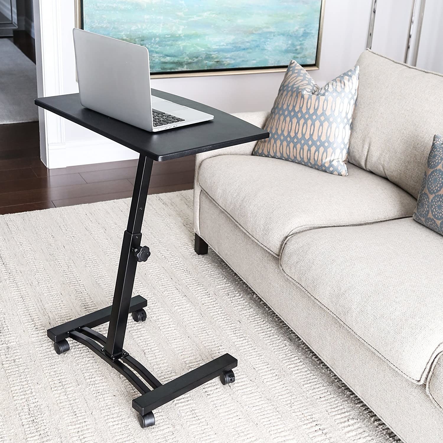 The compact wheeled black adjustable desk  