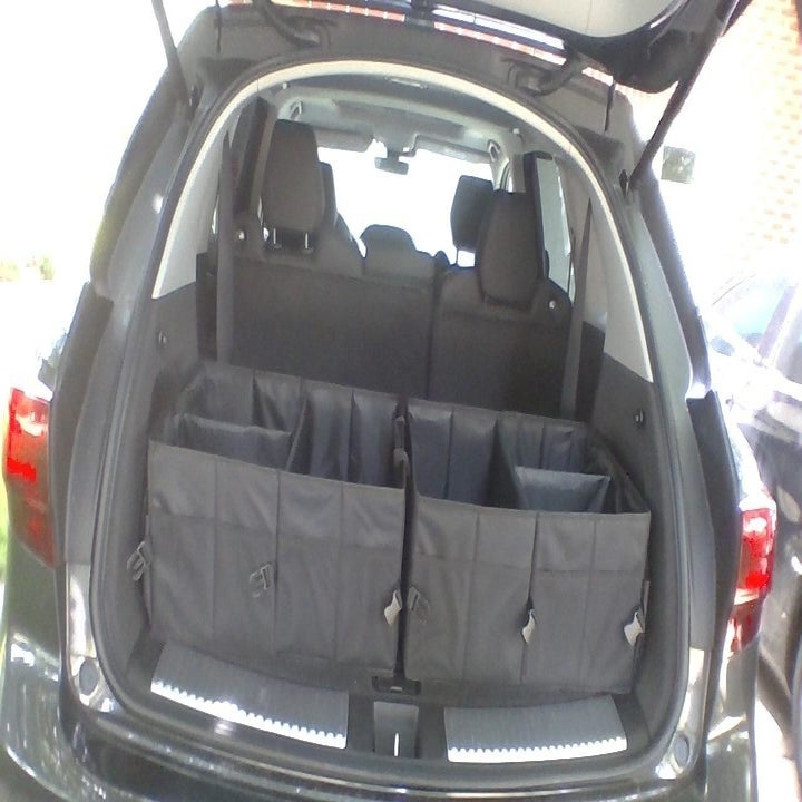 a reviewer's trunk with two organizers in it