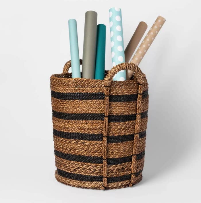 the brown and black cylindrical basket with handles