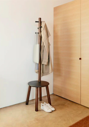 A coat rack with a built-in stool