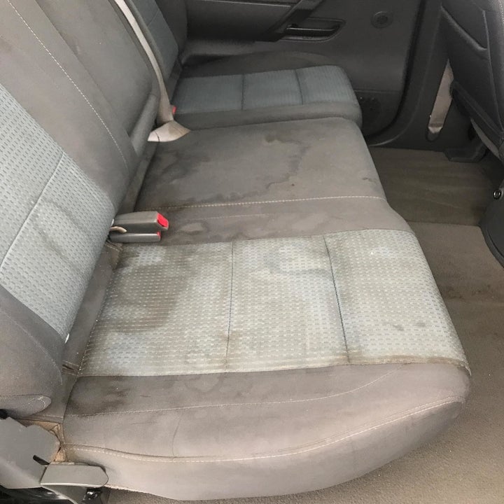 very dirty and stained back seats of a car