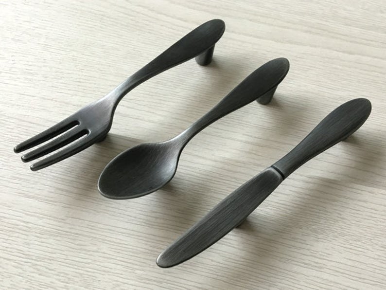 Cabinet handles shaped like a knife, fork, and spoon