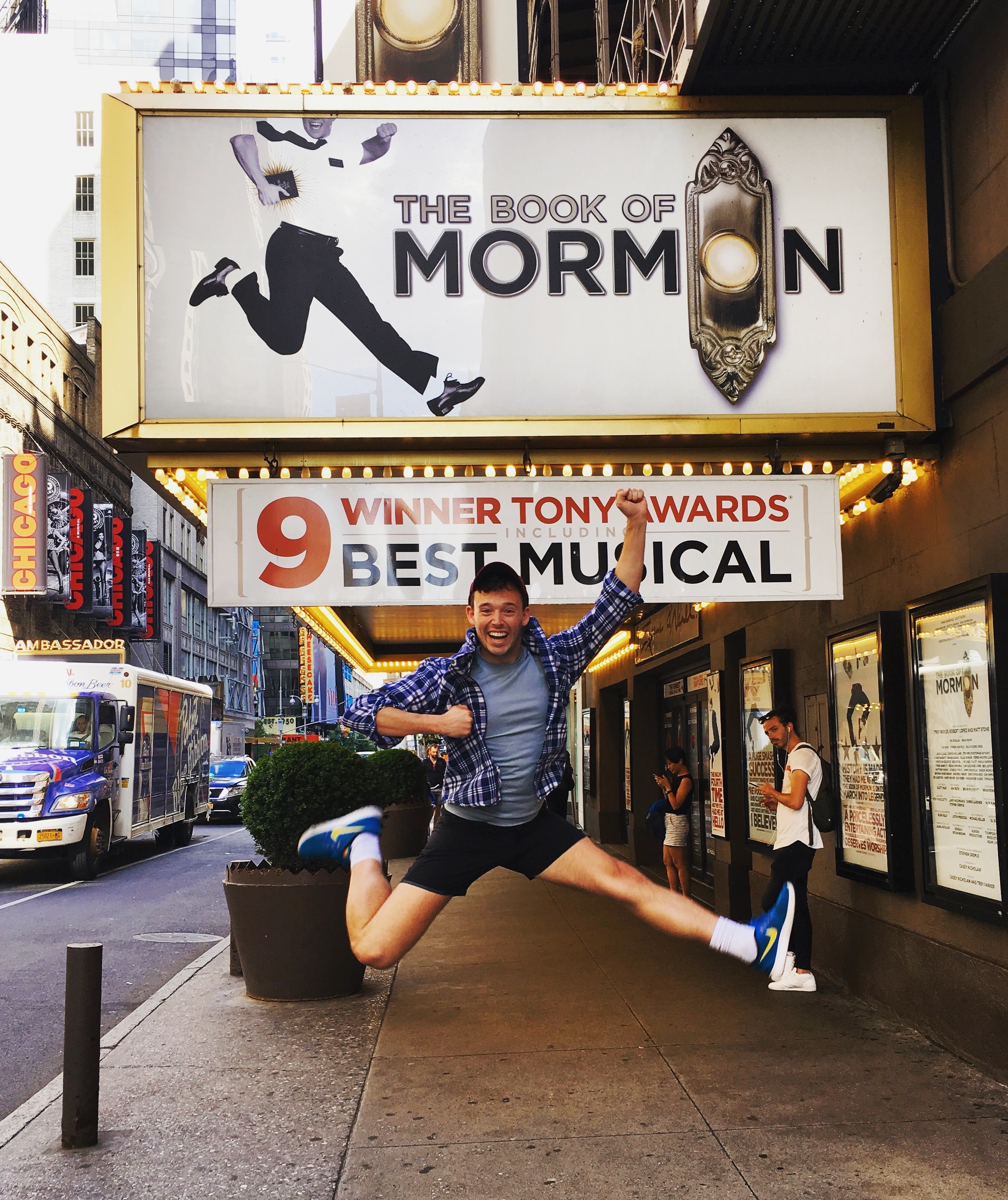 JJ jumping in front of &quot;The Book of Mormon&quot; theater marquee