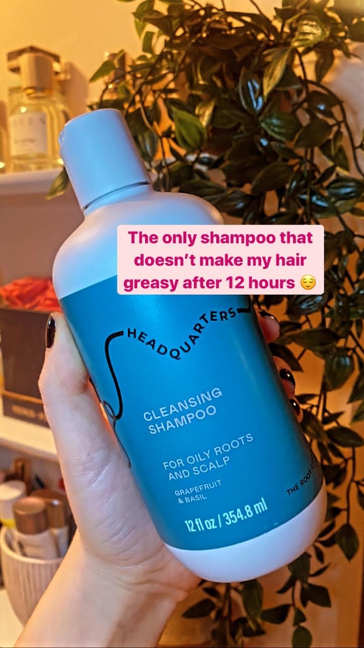 Reviewer holding the shampoo bottle