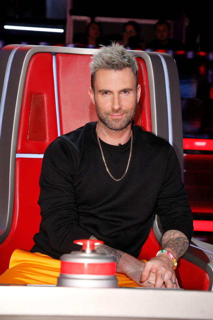 Adam sitting in his judge&#x27;s chair for the show &quot;The Voice&quot;