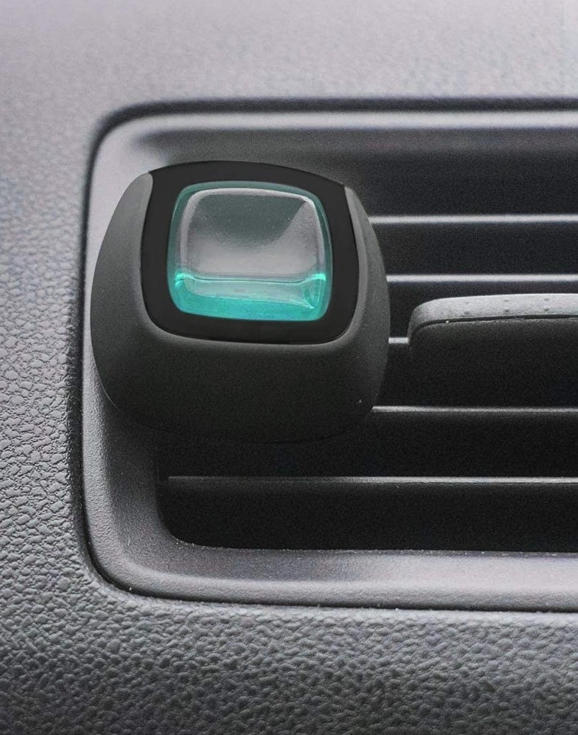 the air freshener in the vent of a car