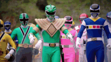 a crowd of power rangers take off their helmets