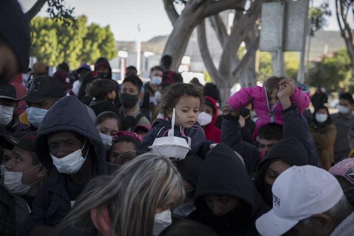 A crowd of adults and children outdoors