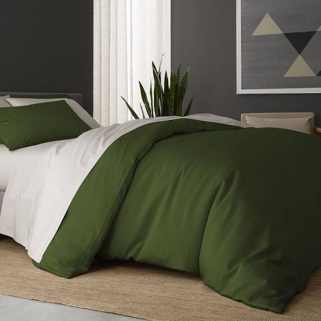the sheet set in snow with a forest green duvet